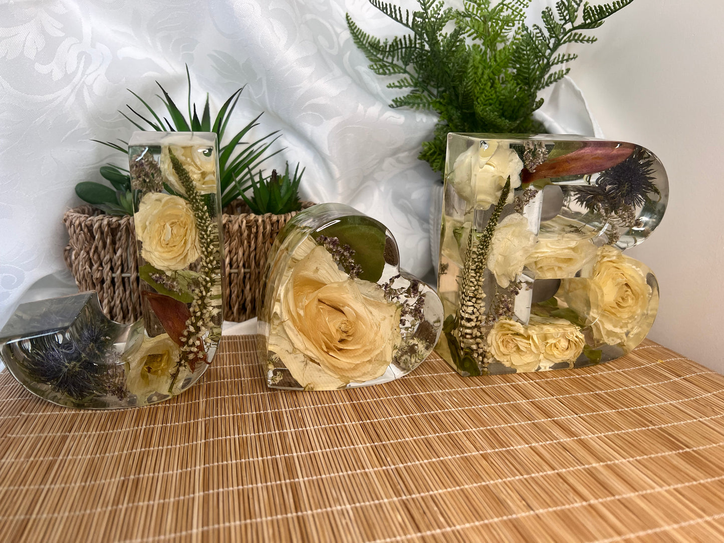 Preserved dried flowers in large resin letters with a 10cm heart. J and B. Includes white roses, white lysianthus, blue thistles and red and green foliage.
