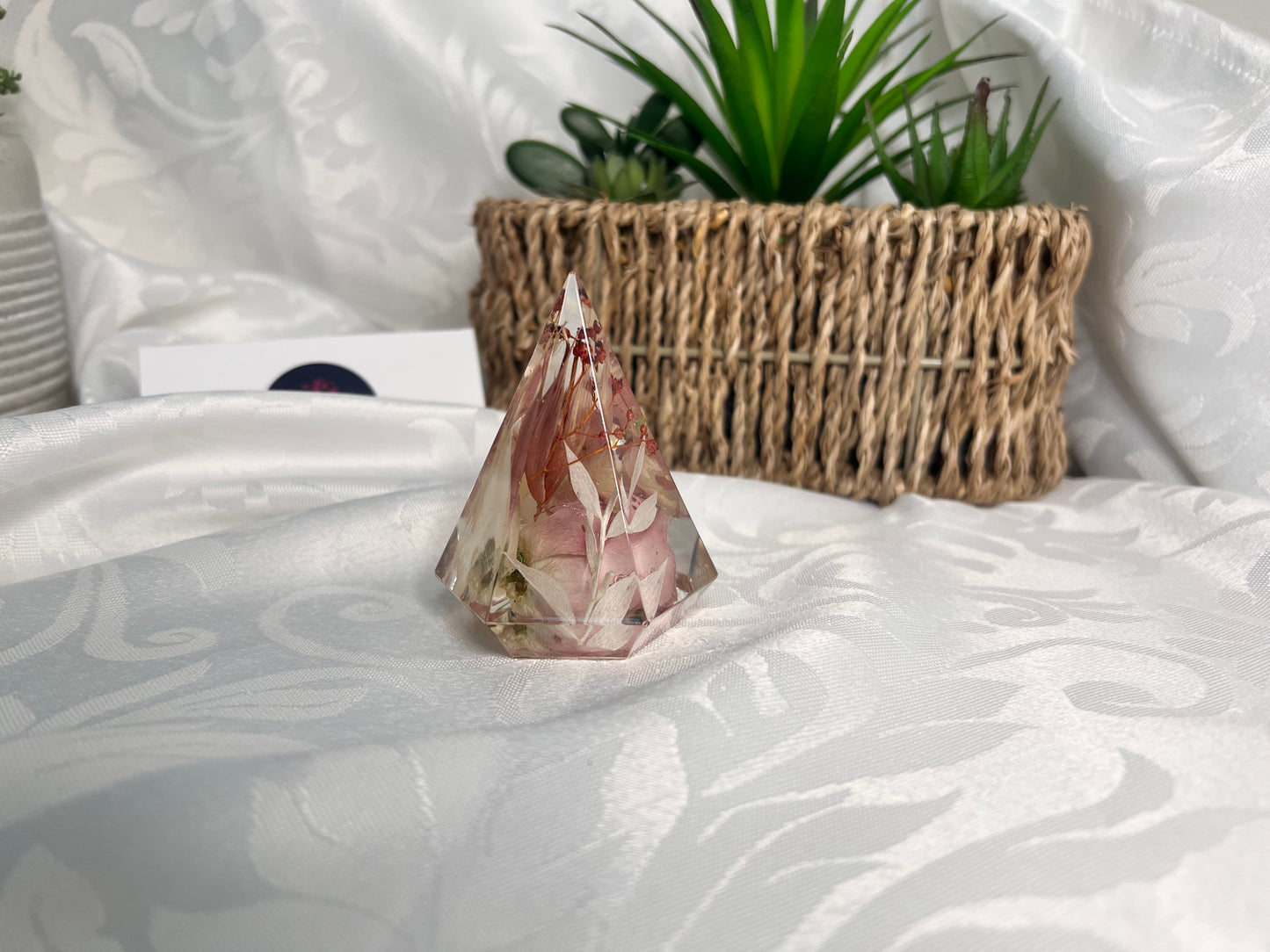 Resin ring holder with red, pink and white flowers and foliage.