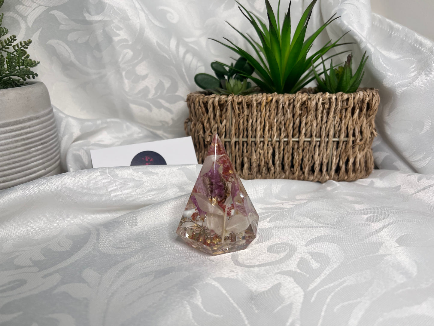 Purple, red, pink and white petals in a resin ring holder with gold flakes.